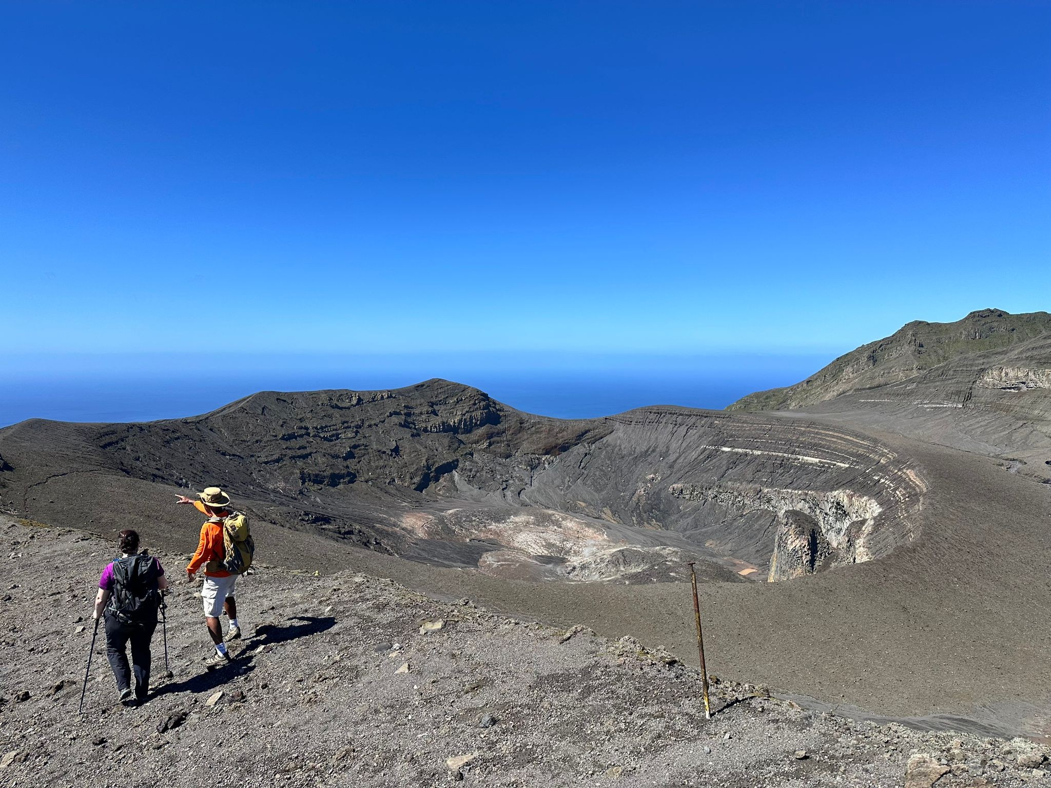 Dr Amelia Bain (UoB project researcher) along with Richie Robertson (SRC) at the crater's edge of the Soufrière volcano in the Caribbean island of St. Vincent.